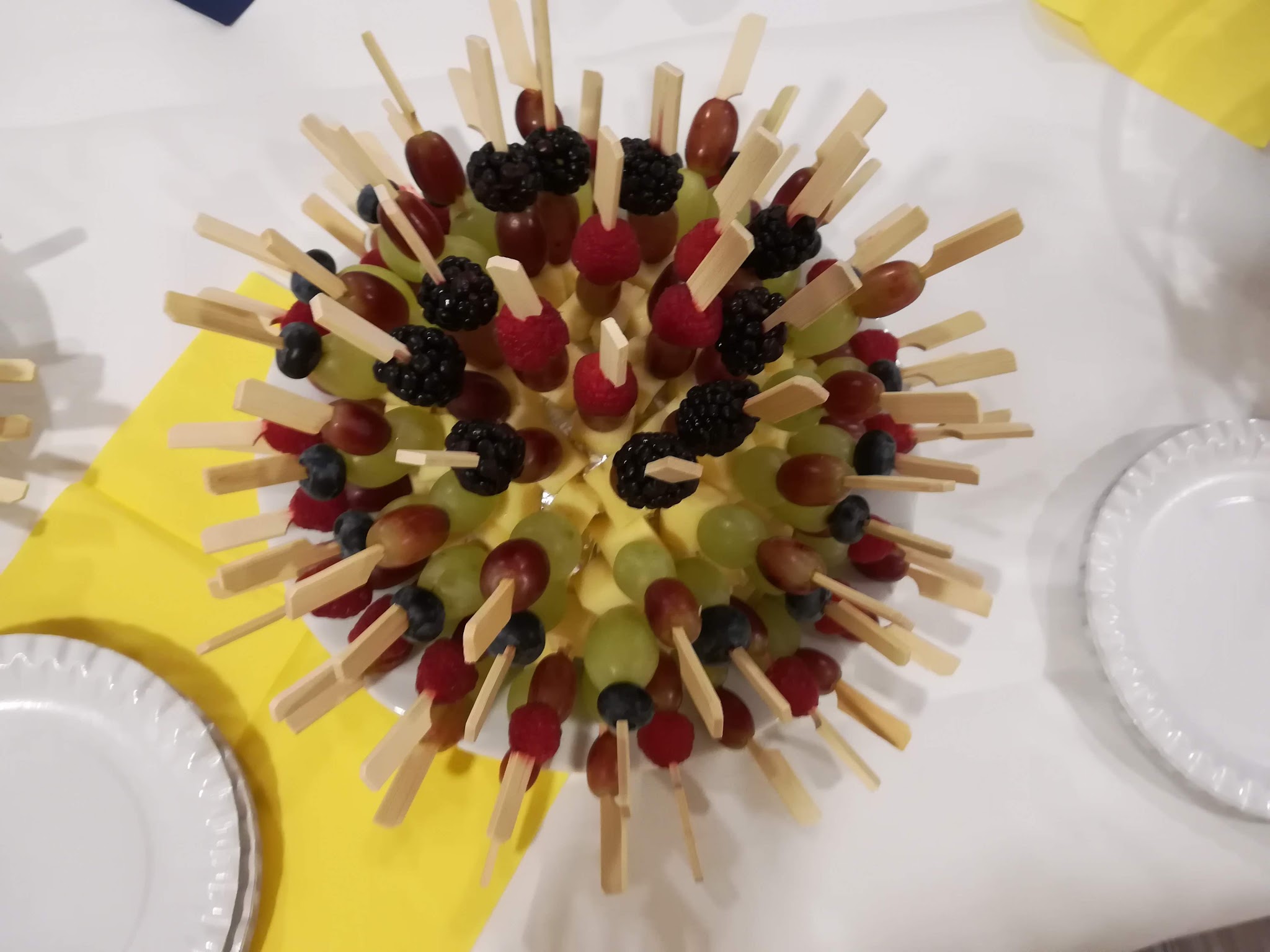 Obst-Igel mit Weintrauben, Beeren und Käse auf Holzspießen